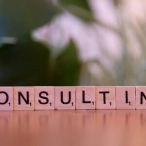 Wooden letter tiles spelling 'Consulting' with a blurred background. Ideal for business concepts.